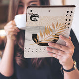 a girl is holding and viewing personalized iPad folio case with Marble Flower design