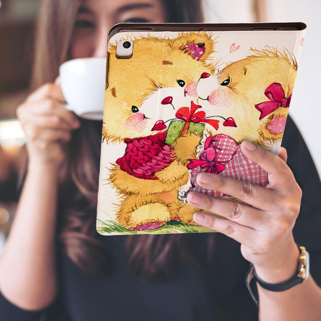 a girl is holding and viewing personalized iPad folio case with Bear design